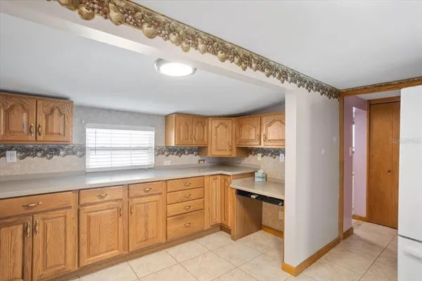 a kitchen with white cabinets and sink