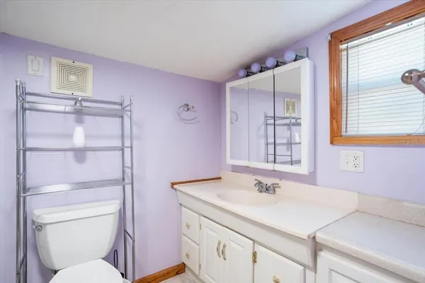 a bathroom with a sink toilet vanity and tub