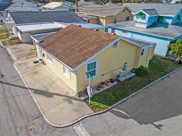 an aerial view of a house with a yard and potted plants