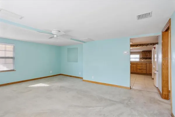 an empty room with closet and windows