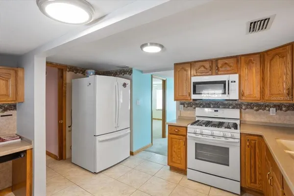 a kitchen with a stove sink and refrigerator