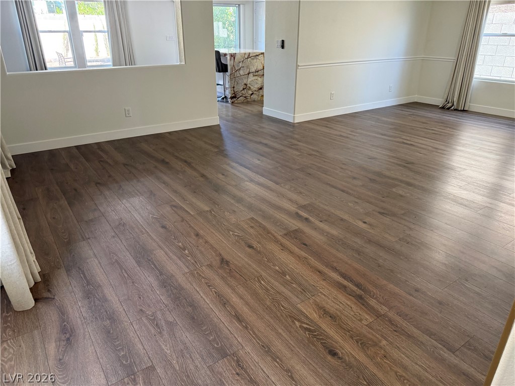 1141 Cathedral Ridge Street Henderson, NV 89052 - Photo 37 of 77 This expansive living area features lustrous hardwood flooring, offering a perfect canvas for personalized design.
