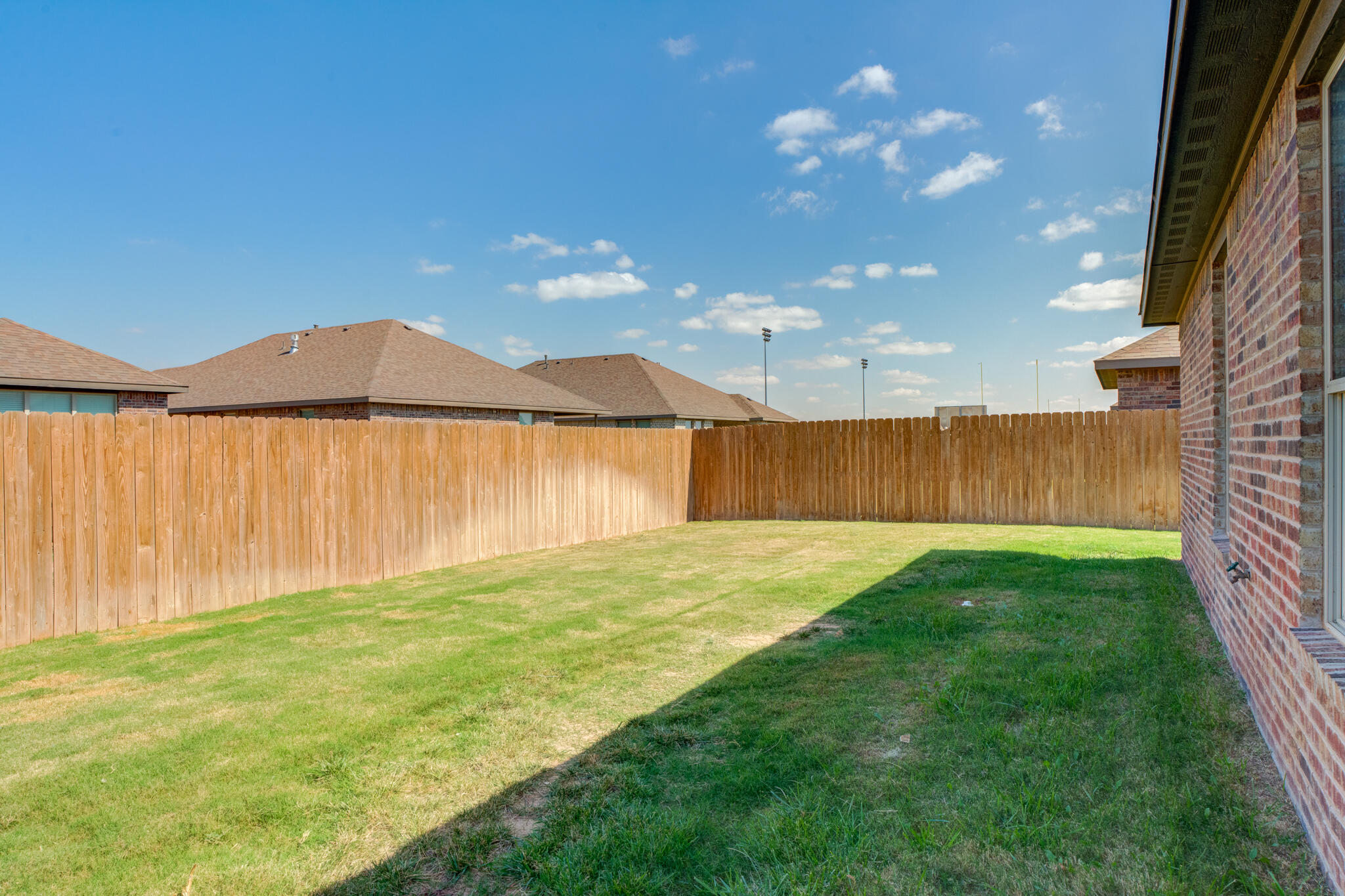 7602 60th Street Lubbock, TX 79407 - Photo 13 of 33 a view of a backyard with a palm tree