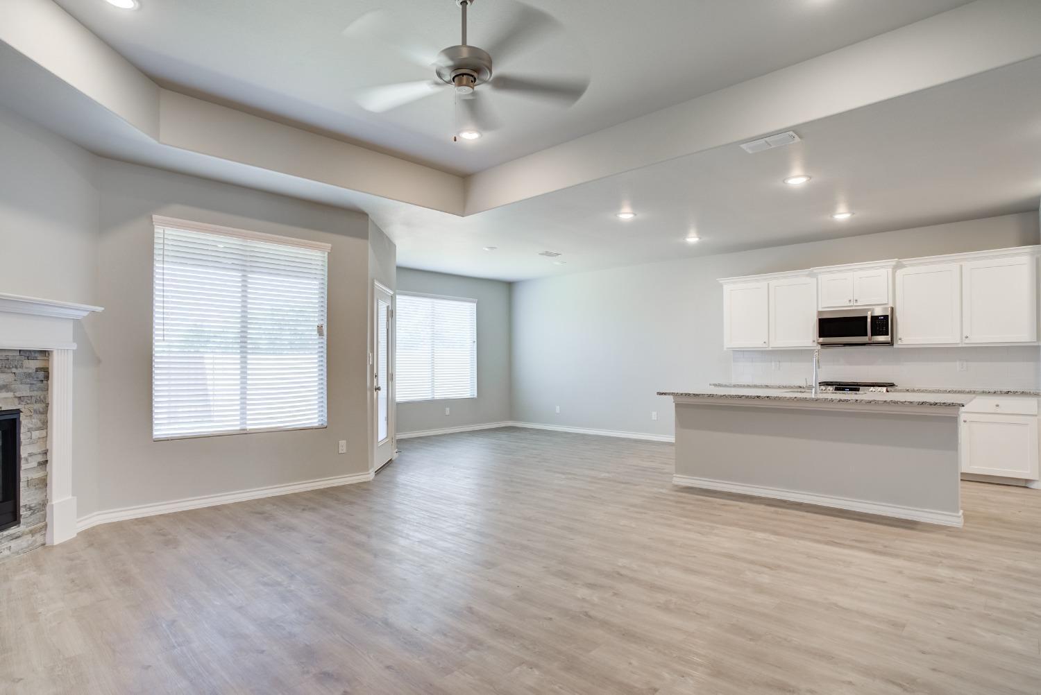 7602 60th Street Lubbock, TX 79407 - Photo 14 of 33 a view of kitchen with sink microwave and stove