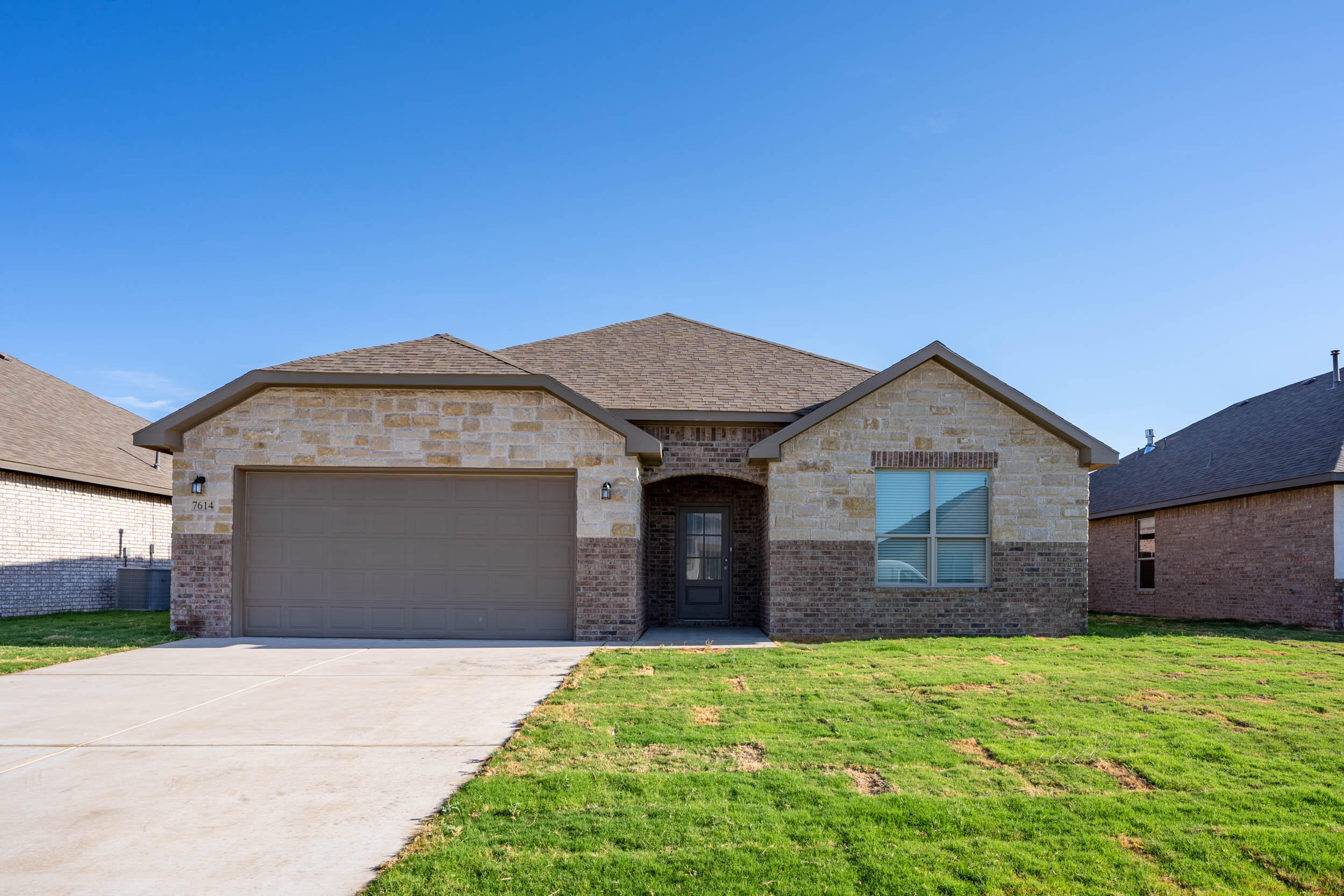 7602 60th Street Lubbock, TX 79407 - Photo 4 of 33 a front view of a house with a garden