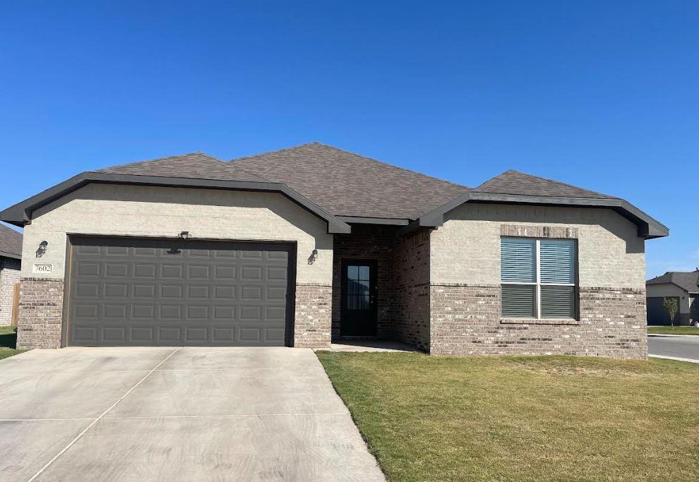 7602 60th Street Lubbock, TX 79407 - Photo 5 of 33 a front view of a house with a garage