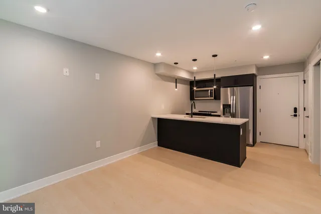 a kitchen with stainless steel appliances a refrigerator and a sink