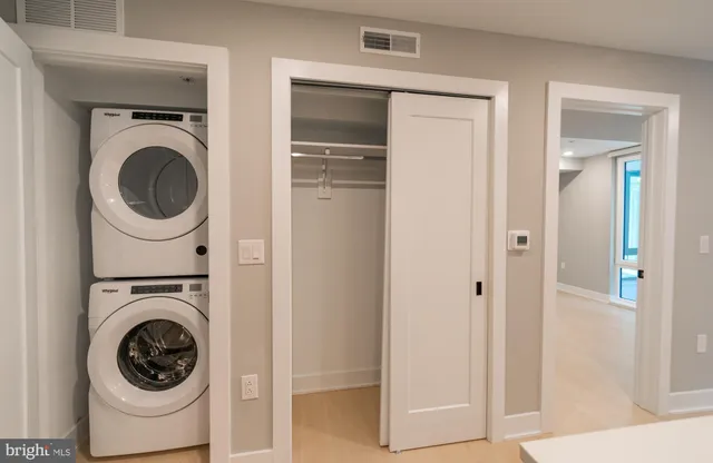 a view of a hallway with washer and dryer