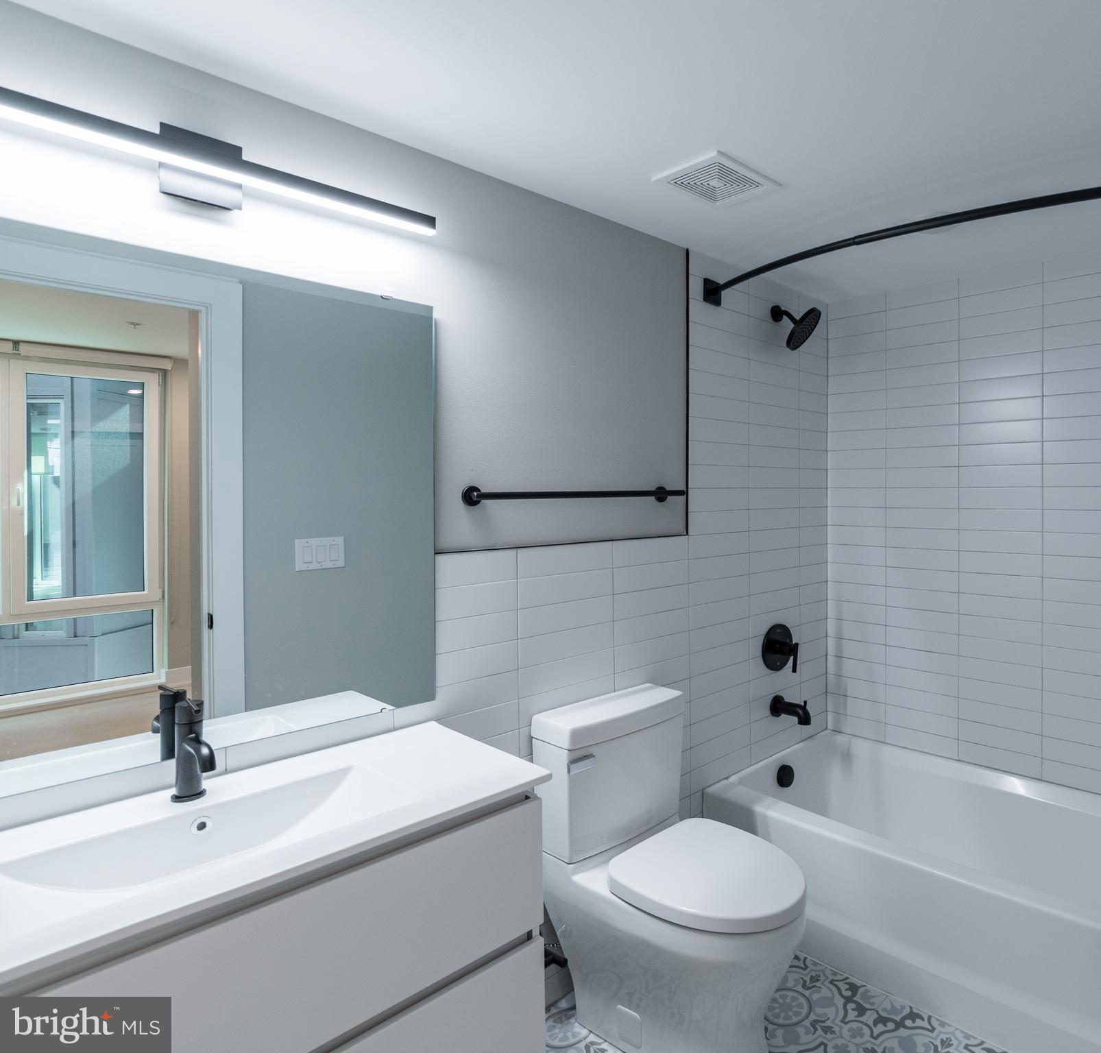 6604 Ridge Avenue, Unit 210 Philadelphia, PA 19128 - Photo 10 of 11 a bathroom with a sink a toilet and a bathtub