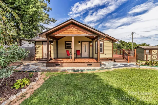 a view of a house with a yard patio and swimming pool