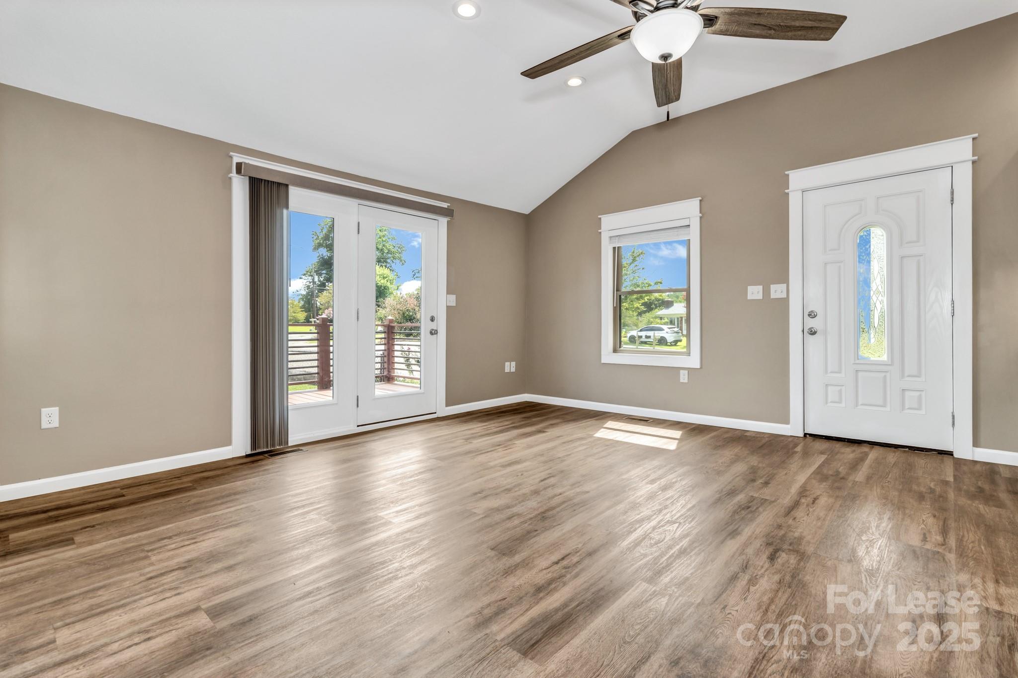 150 Oak Hill Road Candler, NC 28715 - Photo 13 of 44 a view of an empty room with a window and wooden floor
