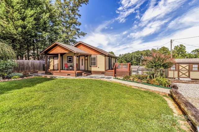 a front view of a house with a yard table and chairs