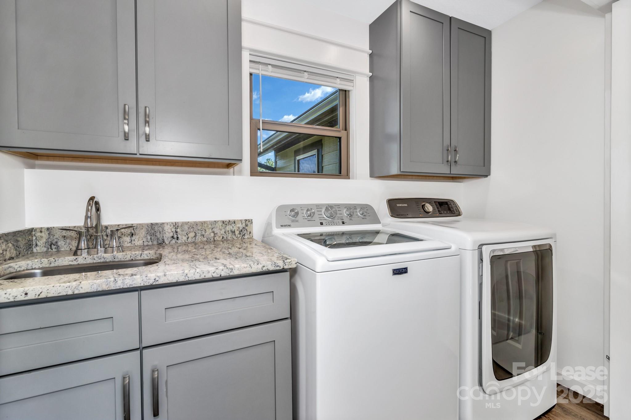 150 Oak Hill Road Candler, NC 28715 - Photo 21 of 44 a utility room with sink dryer and washer