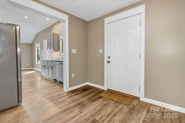 a view of a hallway with wooden floor
