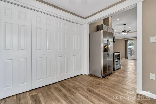 a view of a hallway with wooden floor