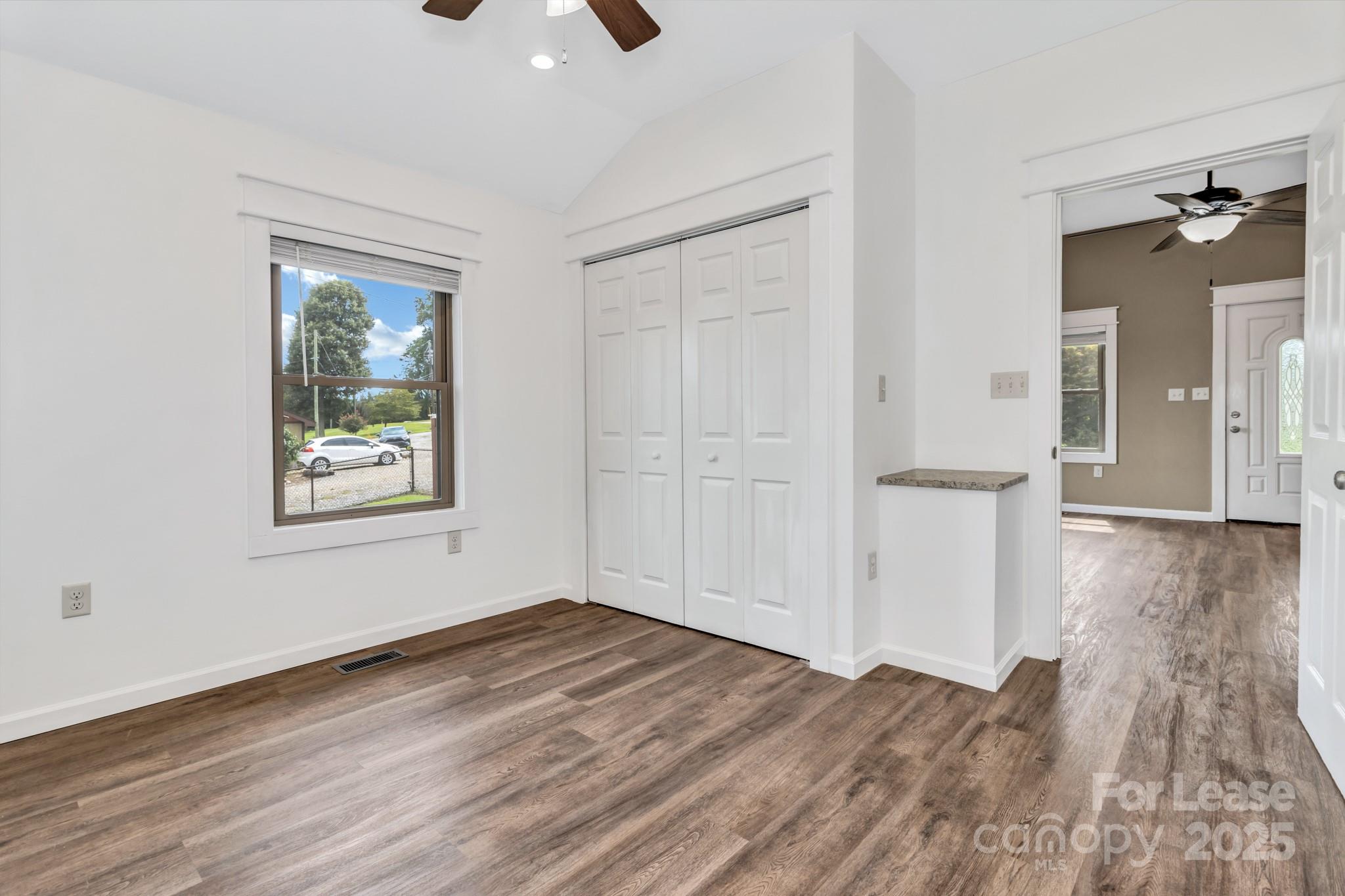 150 Oak Hill Road Candler, NC 28715 - Photo 27 of 44 wooden floor in an empty room with a window
