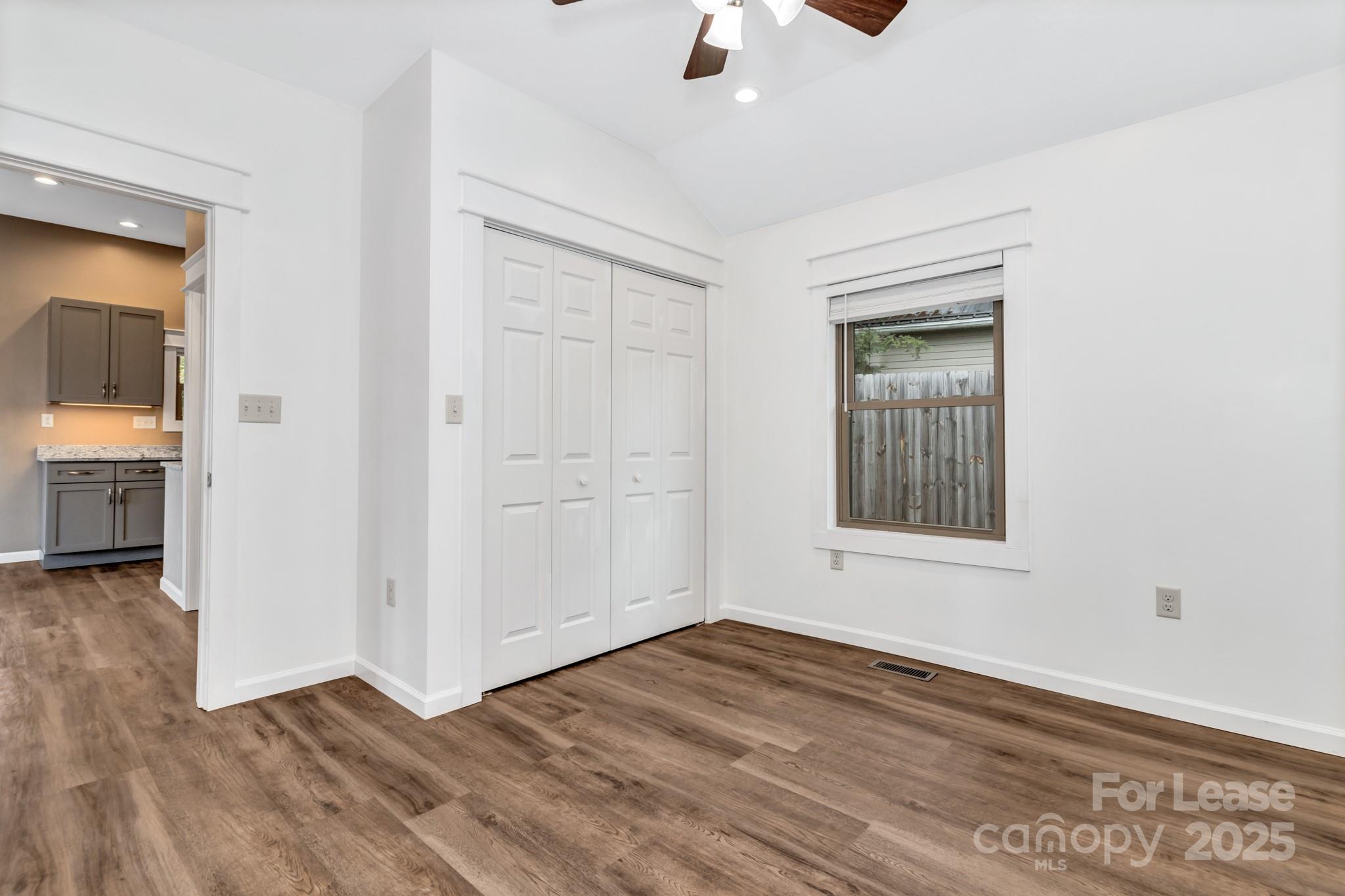 150 Oak Hill Road Candler, NC 28715 - Photo 32 of 44 an empty room with wooden floor and windows
