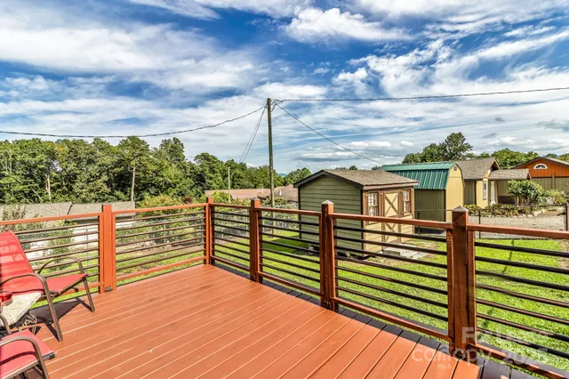 a view of a balcony with wooden floor and city view