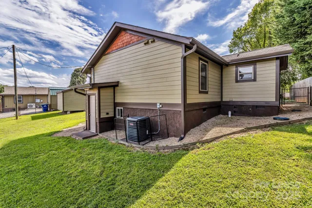 a view of a house with a yard patio and swimming pool