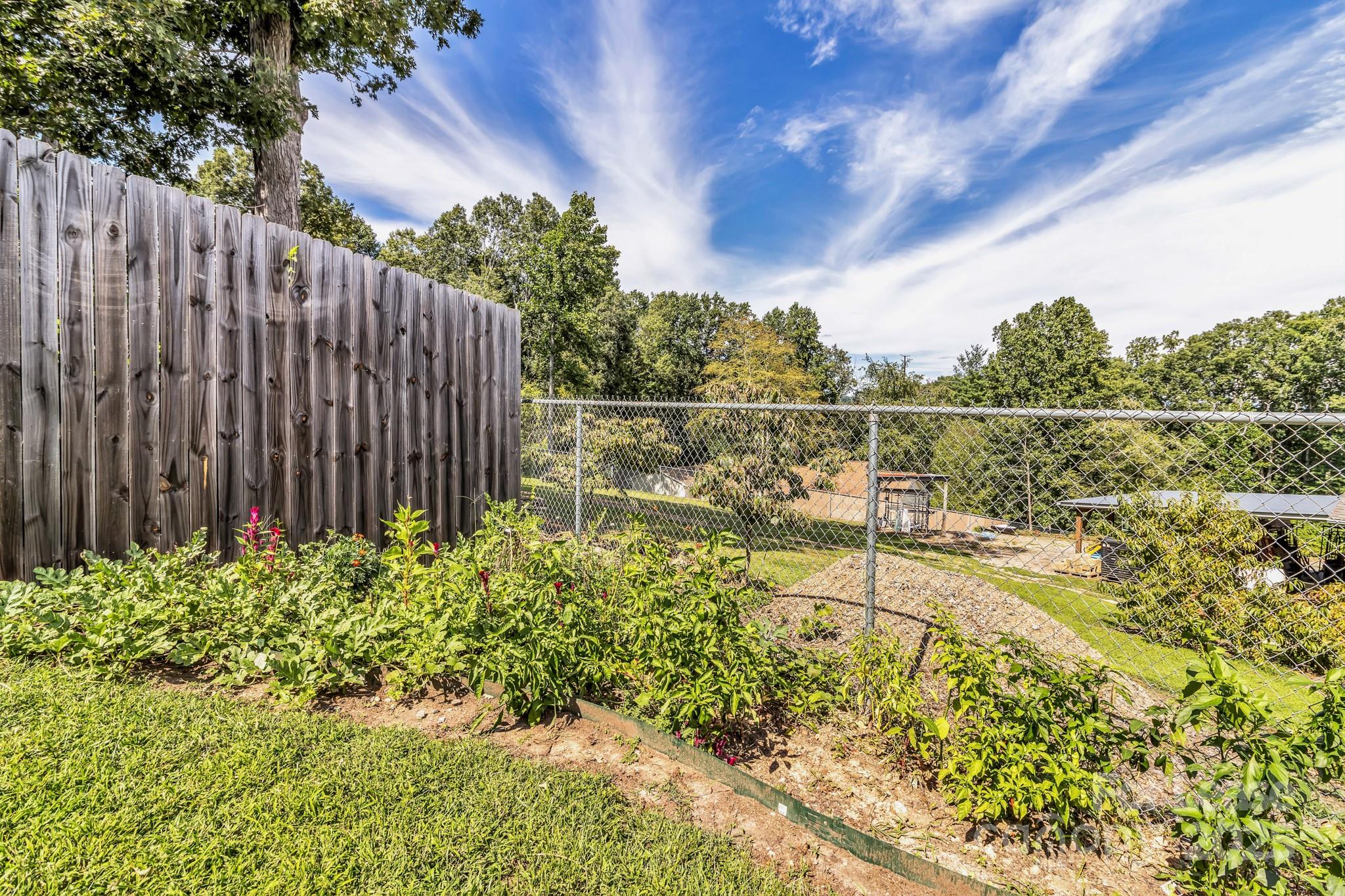 150 Oak Hill Road Candler, NC 28715 - Photo 40 of 44 a view of a garden with a bench