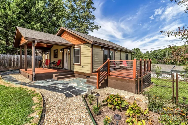a view of backyard with deck and outdoor seating