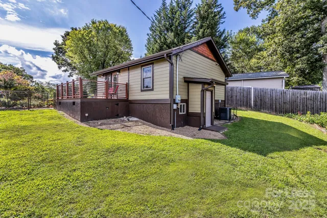 a view of a house with a yard and furniture