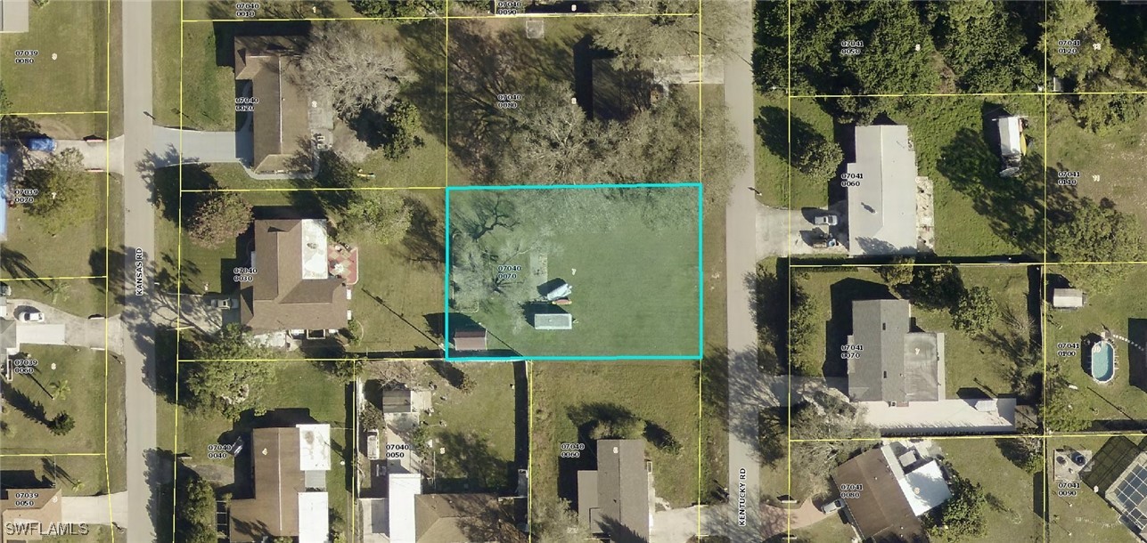 13 Kentucky Road Lehigh Acres, FL 33936 - Photo 1 of 1 an aerial view of a house