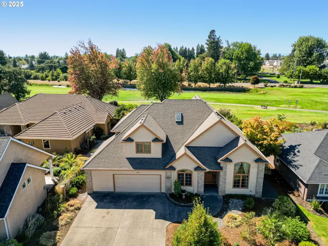 an aerial view of a house with a big yard