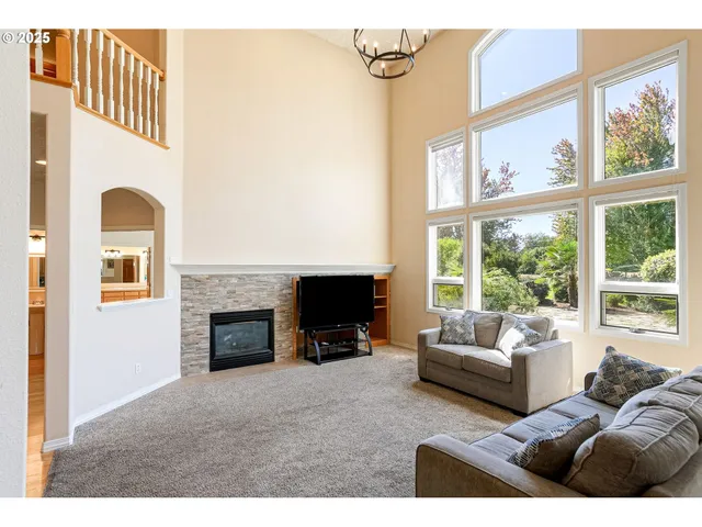 a view of a livingroom with a fireplace and staircase