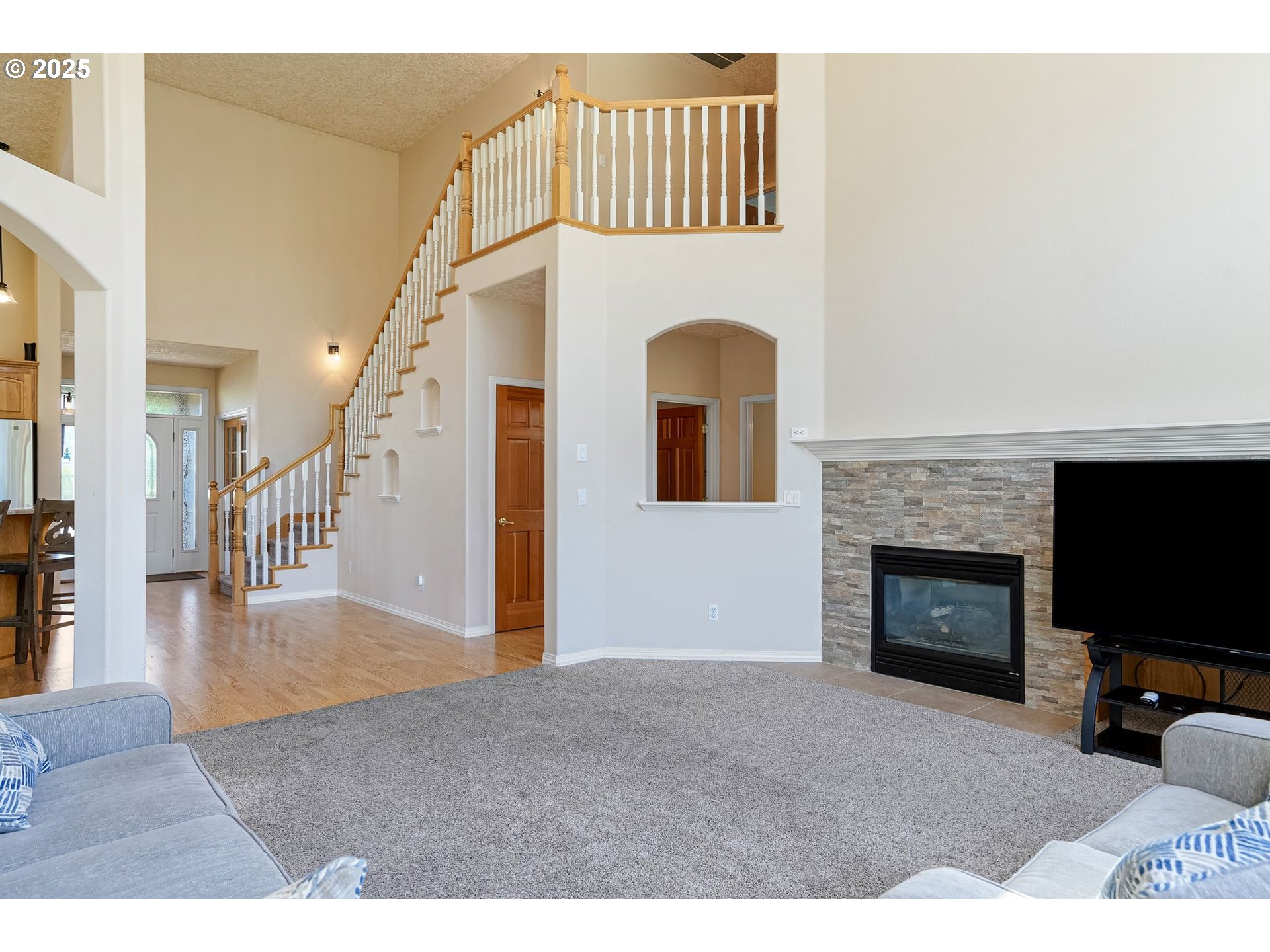 2815 Hazelnut Drive Woodburn, OR 97071 - Photo 13 of 22 a view of a livingroom with a fireplace and staircase