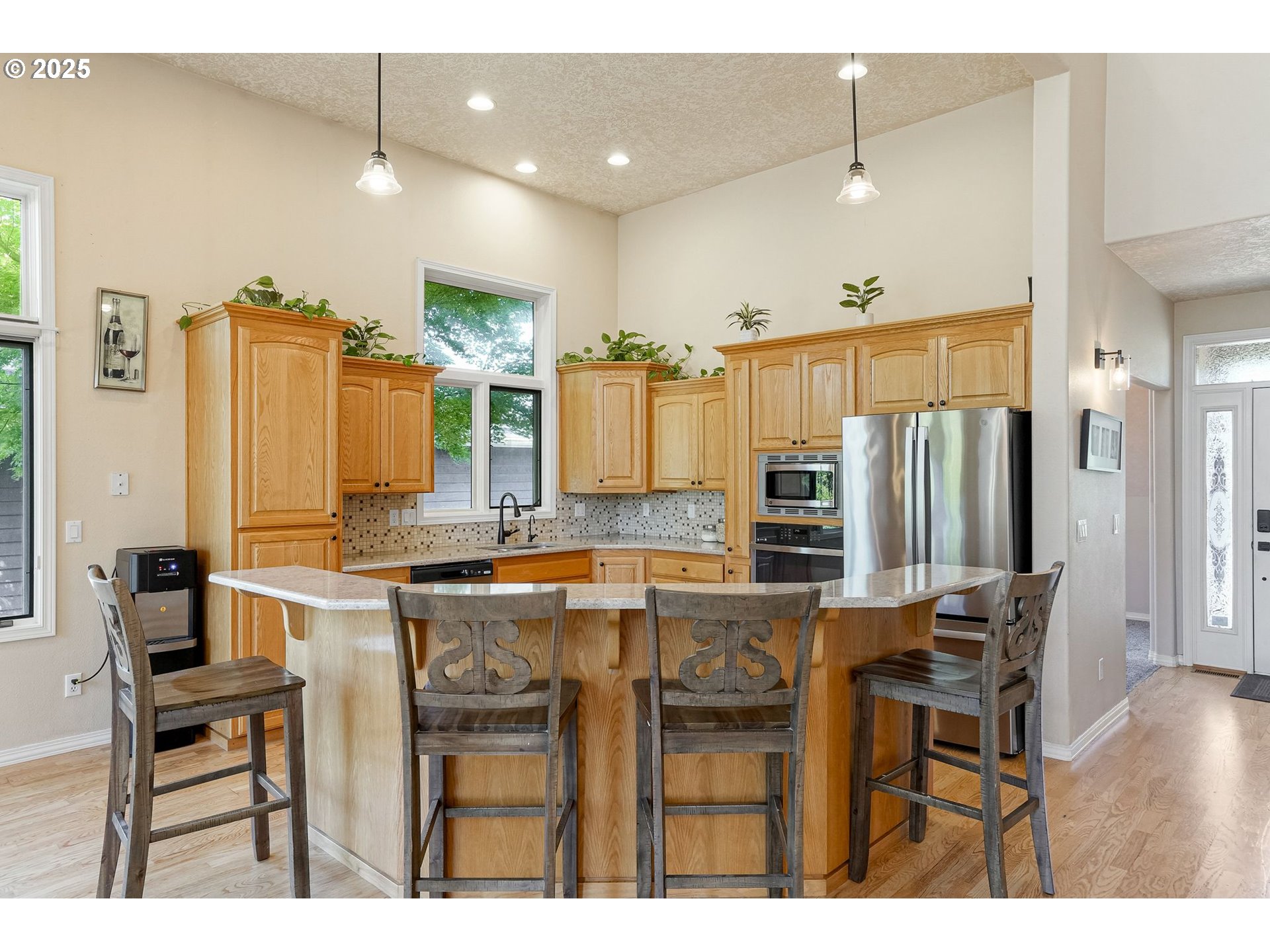 2815 Hazelnut Drive Woodburn, OR 97071 - Photo 16 of 22 a kitchen with stainless steel appliances kitchen island granite countertop a refrigerator and stove