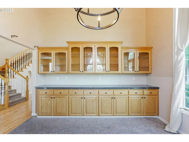 a view of livingroom with furniture wooden floor chandelier and windows