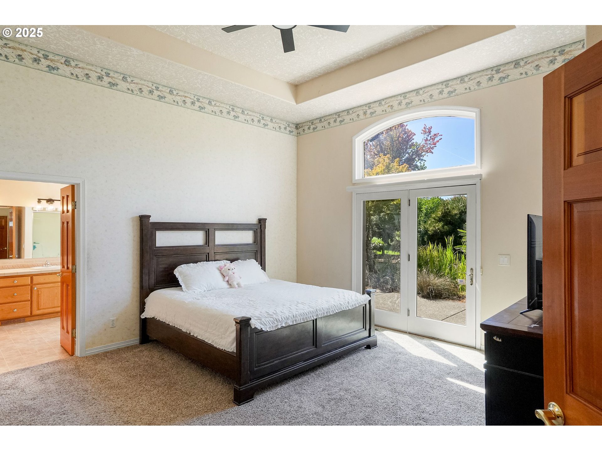 2815 Hazelnut Drive Woodburn, OR 97071 - Photo 19 of 22 a bedroom with a bed lamp and a large window