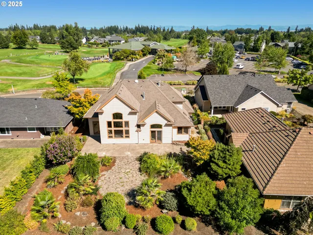 a view of a yard with plants and a bench
