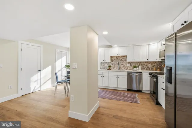 a kitchen with a refrigerator a sink and a stove top oven