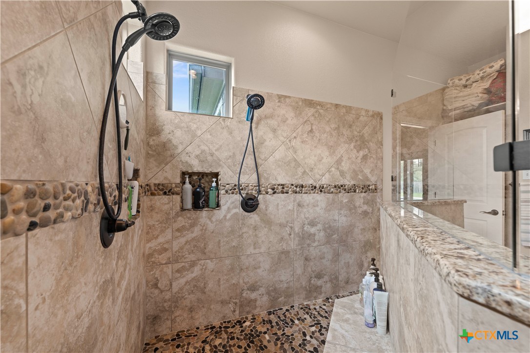 2649 Bowles Ranch Road Belton, TX 76513 - Photo 19 of 36 a bathroom with a granite countertop shower a sink and a mirror