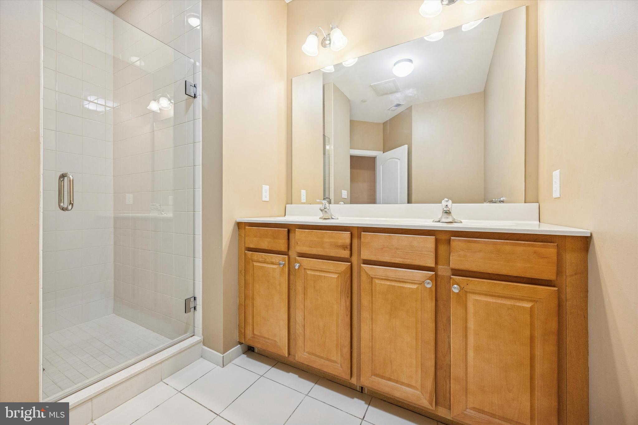 300 Tyler Court, Unit 431 Philadelphia, PA 19111 - Photo 16 of 29 a bathroom with a granite countertop sink mirror and double