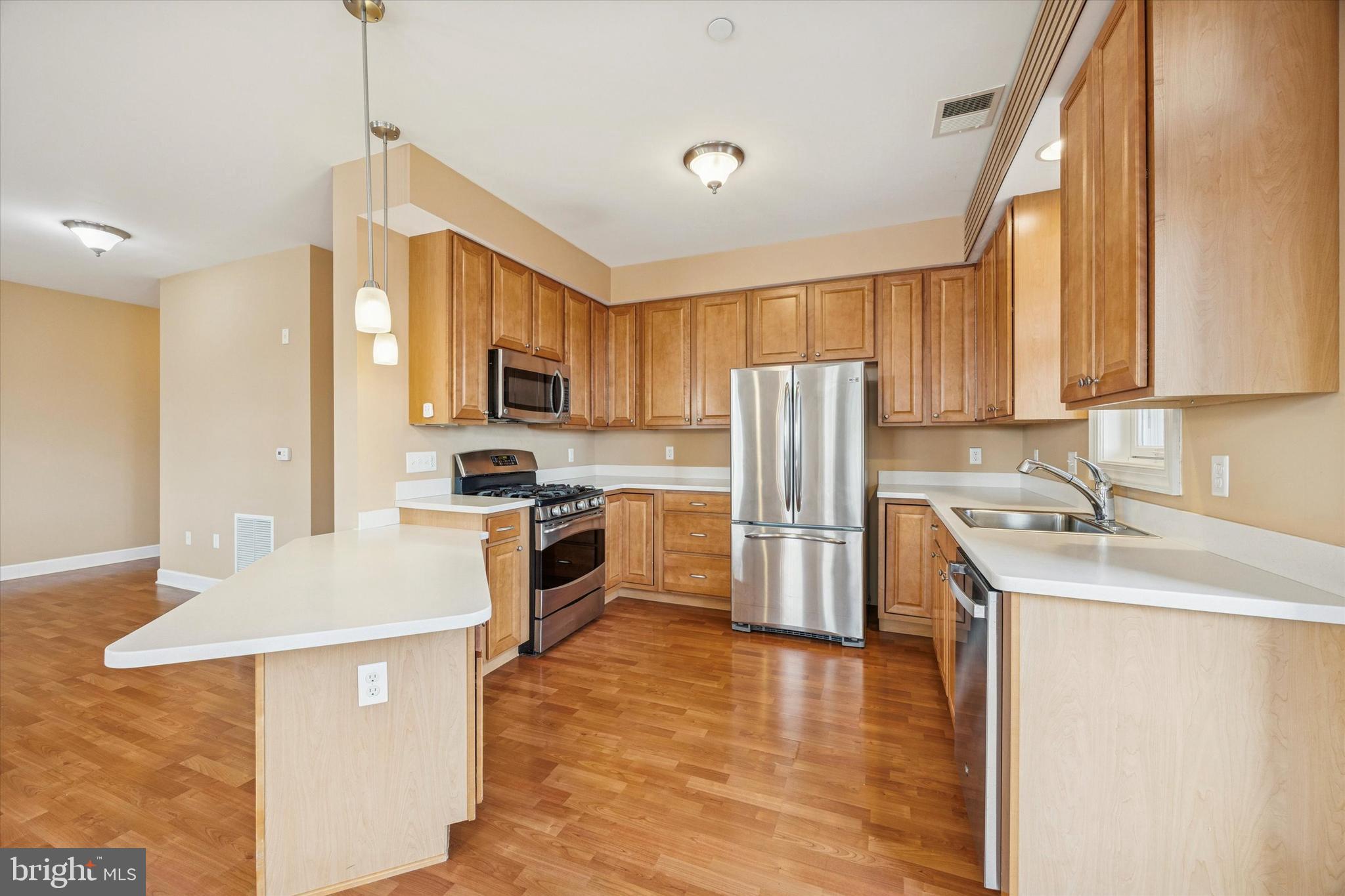 300 Tyler Court, Unit 431 Philadelphia, PA 19111 - Photo 7 of 29 a kitchen with a sink a counter top space stainless steel appliances and cabinets