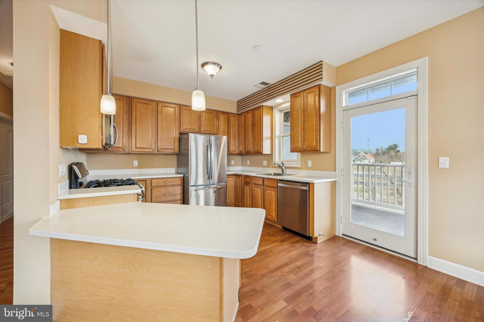 300 Tyler Court, Unit 431 Philadelphia, PA 19111 - Photo 8 of 29 a kitchen with a refrigerator a stove top oven and white kitchen island