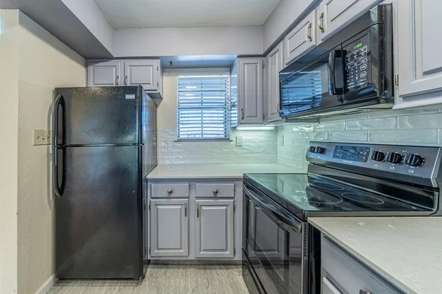 a kitchen with a refrigerator and a sink