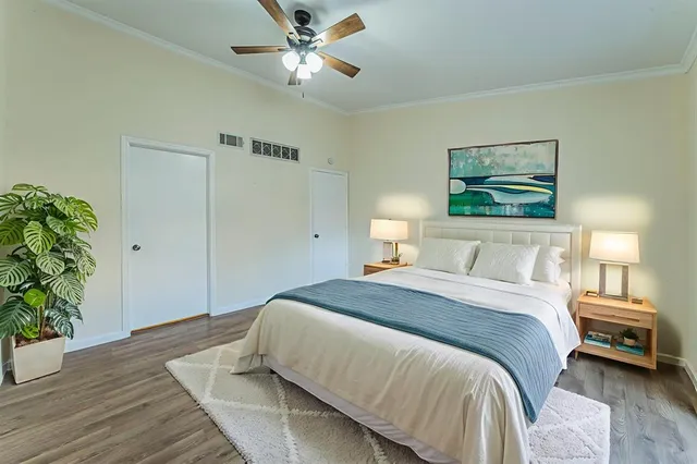a bedroom with a bed and a potted plant