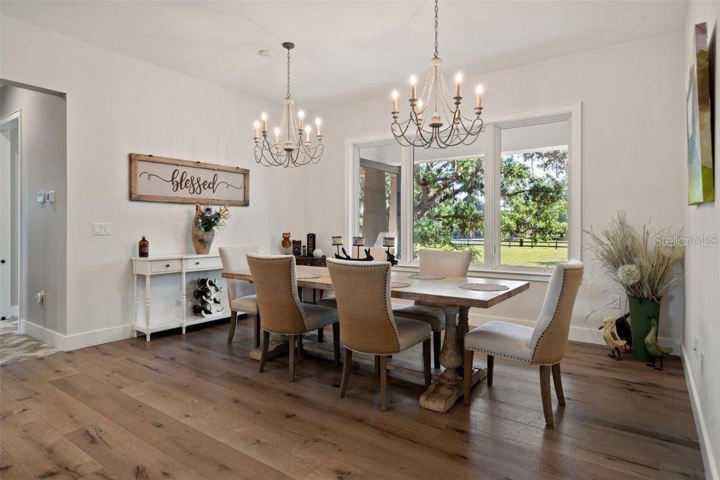 12615 River Road Myakka City, FL 34251 - Photo 21 of 88 a view of a dining room with furniture window and wooden floor