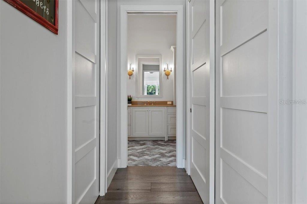 12615 River Road Myakka City, FL 34251 - Photo 25 of 88 a view of a hallway with wooden floor and a bathroom