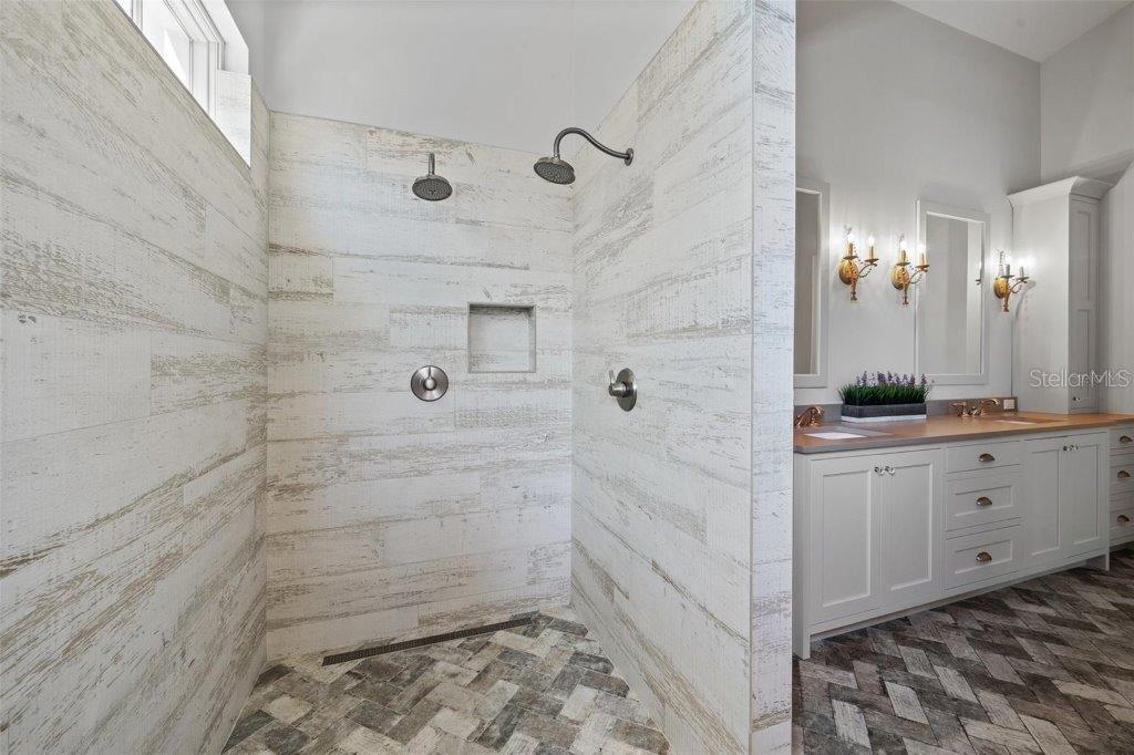12615 River Road Myakka City, FL 34251 - Photo 29 of 88 a bathroom with a double vanity sink and mirror