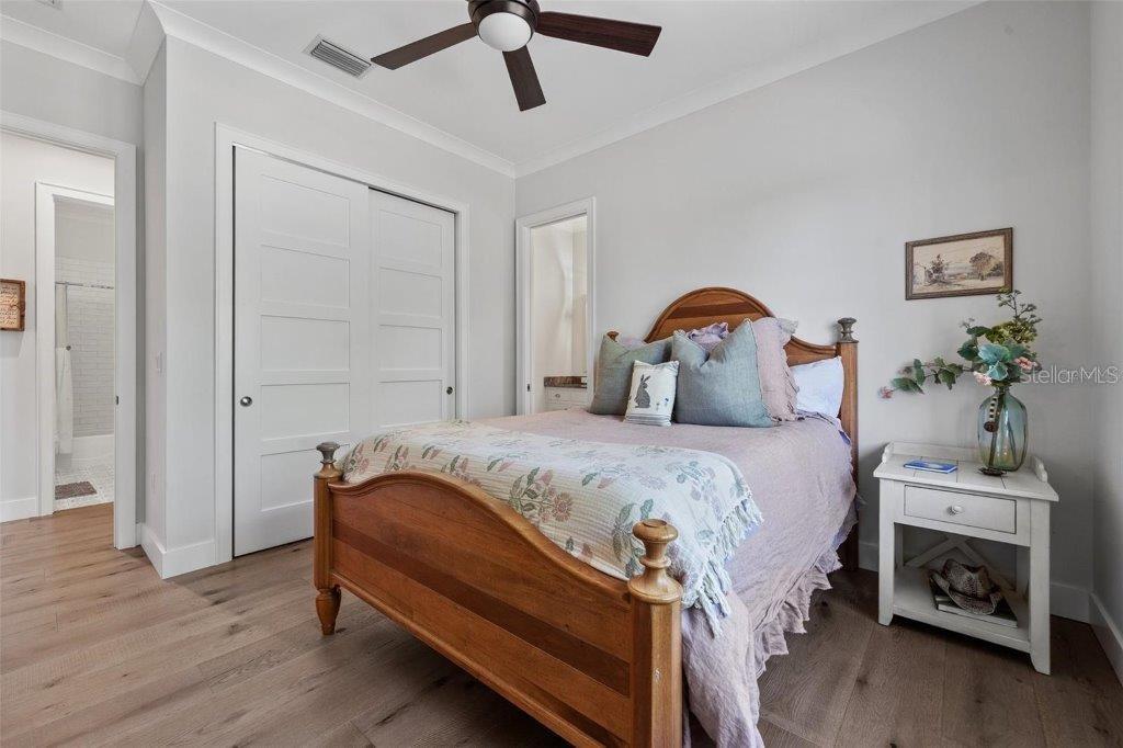 12615 River Road Myakka City, FL 34251 - Photo 33 of 88 a bedroom with a bed and a potted plant