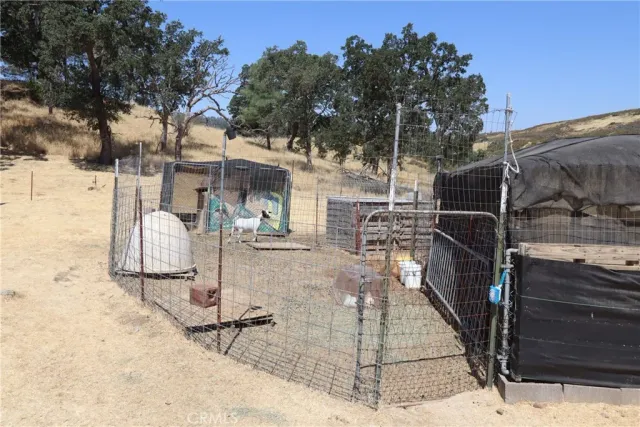 a view of a patio with table and chairs with wooden fence and plants