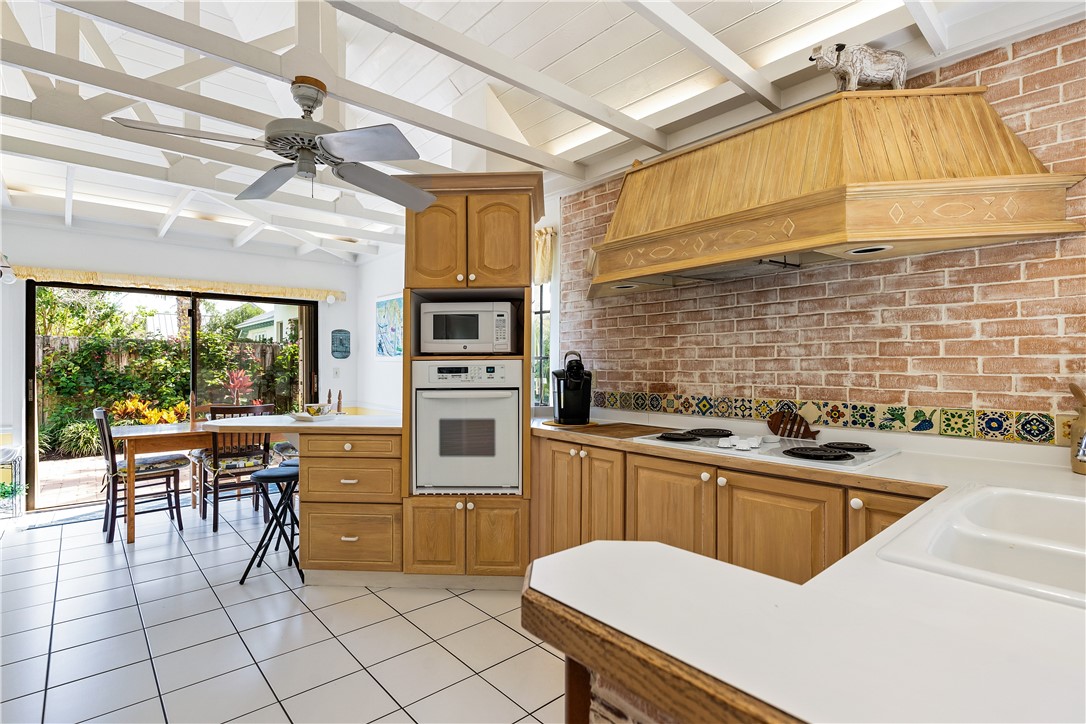 635 Live Oak Road Vero Beach, FL 32963 - Photo 11 of 35 a kitchen with table chairs sink and cabinets