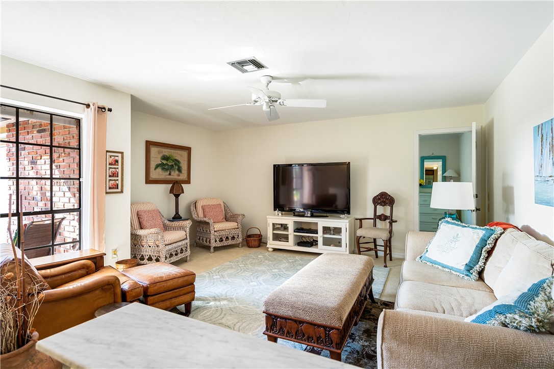 635 Live Oak Road Vero Beach, FL 32963 - Photo 13 of 35 a living room with furniture and a flat screen tv