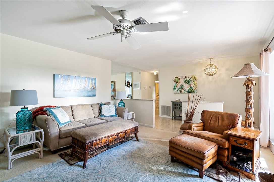 635 Live Oak Road Vero Beach, FL 32963 - Photo 15 of 35 a living room with furniture a ceiling fan and a rug