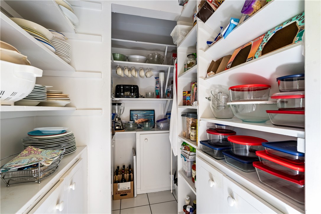 635 Live Oak Road Vero Beach, FL 32963 - Photo 17 of 35 a kitchen with white cabinets and appliances